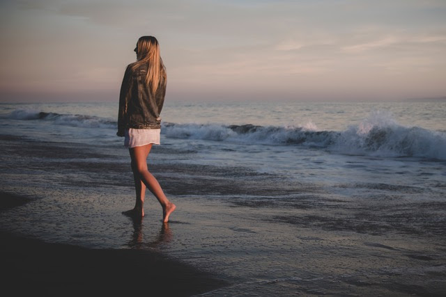 girl walking down a beach
